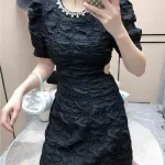 Đầm đen cổ tròn viền đá khoét vai eo